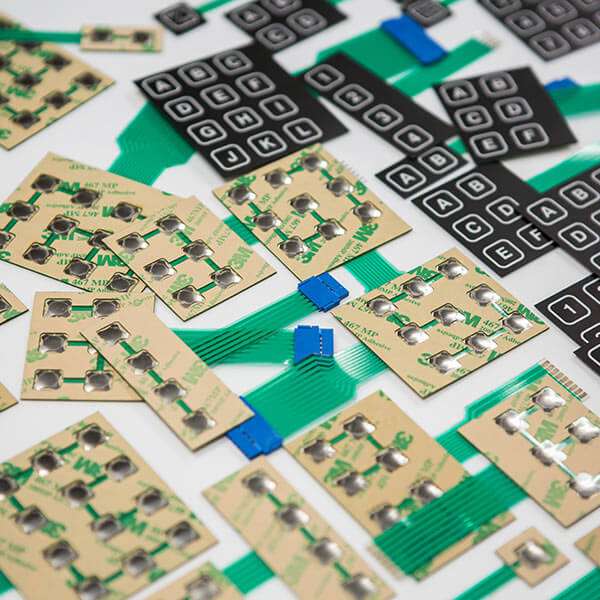 Membrane switch keypad assemblies with flexible circuits and tactile buttons